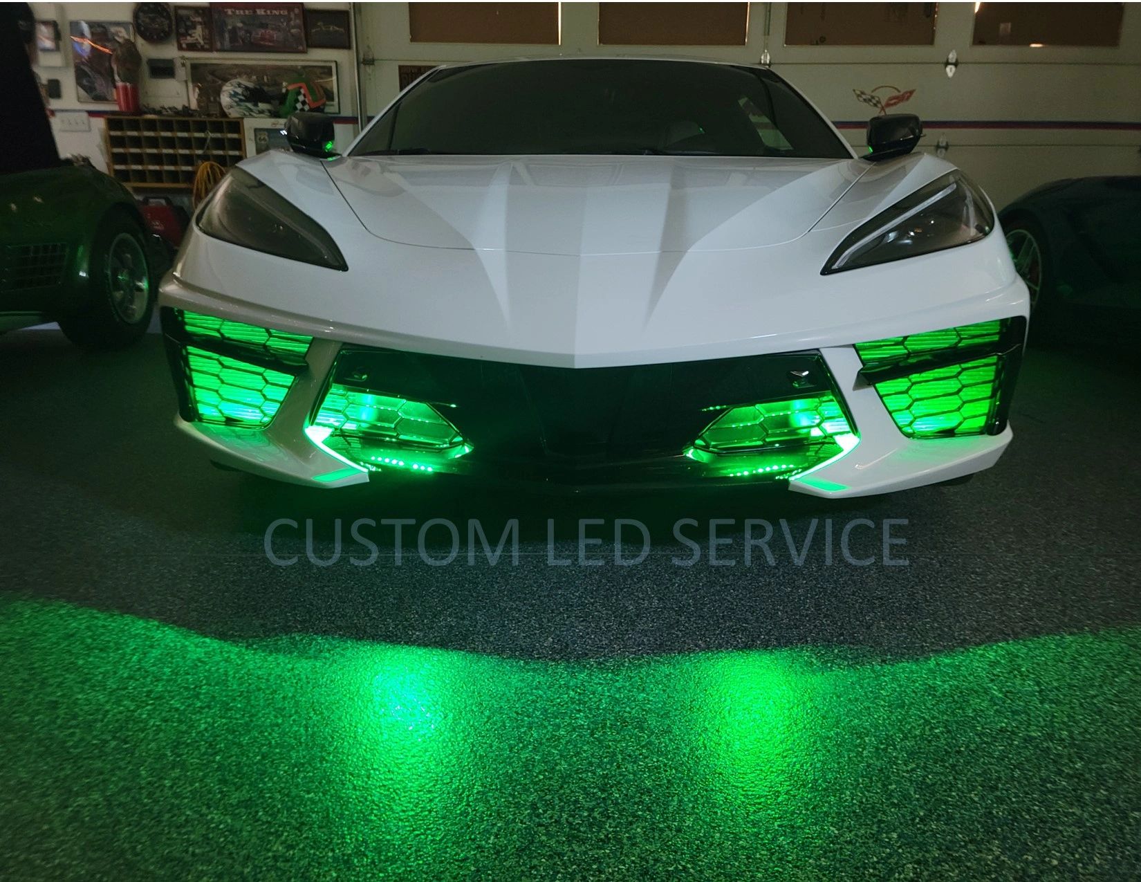 White Corvette C8 with green Custom L.E.D. grille and underbody lighting switched on